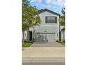 Beautiful exterior of a gray two-story townhome with a well-manicured lawn at 11258 Whistling Pine Way, Orlando, FL 32832