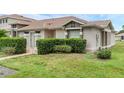Well-manicured front yard of a cozy single-story home with a tiled walkway at 1156 Lucaya Cir, Orlando, FL 32824