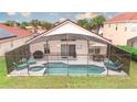 Screened-in pool area featuring a pool, hot tub, lounge chairs, and an outdoor dining set at 117 Rosso Dr, Davenport, FL 33837