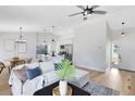 Inviting open-concept living space with a ceiling fan, modern lighting, and seamless flow to the kitchen at 12929 Louisiana Woods Ct, Orlando, FL 32824