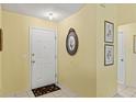 Bright entryway with ceramic tile flooring and neutral walls accented with decorative artwork at 12952 Downstream Cir, Orlando, FL 32828