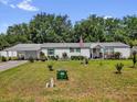 Spacious single-story house with a well-kept lawn and a metal roof at 13009 Plum Lake Cir, Minneola, FL 34715