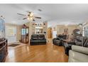 Open-concept living room with hardwood floors and a view of other rooms at 13009 Plum Lake Cir, Minneola, FL 34715