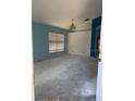 Vacant room with large window and outdated light fixture at 13543 Emeraldview Dr, Orlando, FL 32828