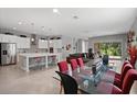 Spacious living and dining area featuring recessed lighting, tile floors, and an island kitchen at 14138 Alafaya Oak Bnd, Orlando, FL 32828
