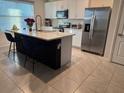 Bright kitchen with white cabinets, stainless steel appliances, and a large center island at 1832 Katz Crossing Dr, Kissimmee, FL 34744