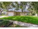 Charming single-story home with a well-maintained lawn and mature trees, creating a welcoming curb appeal at 196 Morning Glory Dr, Lake Mary, FL 32746