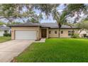 Charming single-story home features a well-maintained lawn, mature trees, and a two-car garage at 196 Morning Glory Dr, Lake Mary, FL 32746
