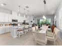 Bright kitchen with white cabinets, stainless steel appliances, and a large island with bar stool seating at 2301 Datura Loop, St Cloud, FL 34772