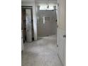 Renovated bathroom features a walk-in shower with marble tiling and neutral-colored flooring at 233 Red Maple Dr, Kissimmee, FL 34743