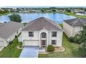 An elevated view of the home, showcasing its well-maintained yard and lake view at 2384 Andrews Valley Dr, Kissimmee, FL 34758