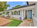 Inviting front porch with brick accents, rocking chairs, and charming curb appeal at 2450 Mcintosh Way, Maitland, FL 32751