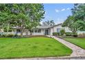 Charming single-story home with lush lawn, brick walkway, and inviting curb appeal at 2450 Mcintosh Way, Maitland, FL 32751