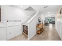 Bright entryway featuring tile flooring, wainscoting, and an open view into the living and dining areas at 266 Caryota Ct, New Smyrna Beach, FL 32168