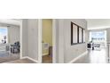 Hallway featuring tiled floors and wall niches that connect the living room and other areas of the home at 2665 Trinidad Rd, Haines City, FL 33844