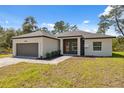 Inviting single-story home featuring a two car garage, modern design, and well-maintained landscaping at 3072 Sw 168Th Loop, Ocala, FL 34473