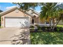 Beautiful single-Gathering home featuring a two-car garage and well-manicured landscaping and inviting entryway at 3078 Mandolin Dr, Kissimmee, FL 34744