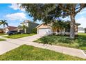 Inviting single-Gathering home with a well-maintained lawn, mature landscaping, and a two-car garage at 3078 Mandolin Dr, Kissimmee, FL 34744