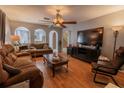 Inviting living room with hardwood floors, ceiling fan, and natural light at 3216 White Blossom Ln, Clermont, FL 34711