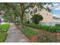 Inviting home featuring lush landscaping, mature trees and a white picket fence that enhances its curb appeal at 4001 Corrine Dr, Orlando, FL 32814