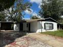 Exterior view of the home showcasing its carport, covered entrance, and simple architectural style at 4061 Kirkland Blvd, Orlando, FL 32811
