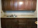 Kitchen cabinets showcase a classic style, complemented by the sleek granite countertops and modern sink at 4061 Kirkland Blvd, Orlando, FL 32811