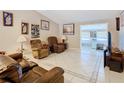Cozy living room features comfortable furniture, tile flooring, and neutral wall color for a relaxing atmosphere at 4432 Freedom Rd, Kissimmee, FL 34746