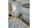 Bright guest bedroom with two twin beds, a surfboard decoration, and access to the ensuite bathroom at 4453 S Atlantic Ave # 602, Ponce Inlet, FL 32127