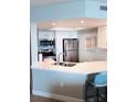 Bright kitchen features white cabinets, stainless steel appliances, and a breakfast bar with seating at 4453 S Atlantic Ave # 602, Ponce Inlet, FL 32127