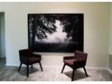 Minimalist interior featuring two chairs and large artwork, creating a serene and modern living space at 548 Glen Haven Dr, Deltona, FL 32738