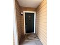 Charming front door entrance with a welcome mat and ample lighting, inviting guests inside at 5540 Devonbriar Way # 103, Orlando, FL 32822