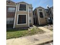 Inviting multi-story townhome with neutral siding, screened balconies, and well-maintained landscaping at 5540 Devonbriar Way # 103, Orlando, FL 32822