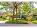 Charming home with a covered parking area, front porch and lush landscaping at 607 W Club Blvd, Lake Mary, FL 32746