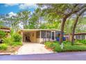 Charming home featuring a covered parking area, front porch and mature landscaping at 607 W Club Blvd, Lake Mary, FL 32746