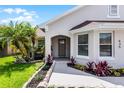 Close-up of a charming single-story home featuring a well-maintained lawn and meticulously landscaped entryway at 635 Holbrook Cir, Lake Mary, FL 32746