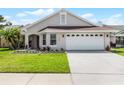 Charming single-story home featuring a well-maintained lawn and a two-car garage, under a sunny sky at 635 Holbrook Cir, Lake Mary, FL 32746