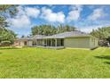 Back exterior view highlighting the screened porch, spacious yard, and home's architectural details at 638 Sun Bluff Ln, Apopka, FL 32712