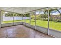 Inviting screened porch with tile flooring, providing a relaxing outdoor living space overlooking the yard at 638 Sun Bluff Ln, Apopka, FL 32712