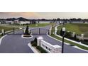 Gated community entrance featuring a decorative stone sign and well-maintained landscaping at 6686 Treymont Dr, Lakeland, FL 33813