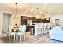 Modern kitchen with stainless steel appliances, pendant lighting, and a large island at 6686 Treymont Dr, Lakeland, FL 33813