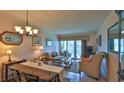 Cozy living room with tile floors, neutral walls, and access to the screened porch at 717 S Beach St # 205C, Daytona Beach, FL 32114