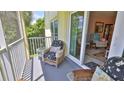 Comfortable seating on a screened porch, with a view to the outdoors at 717 S Beach St # 205C, Daytona Beach, FL 32114