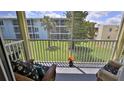 Relaxing screened patio with cushioned seating overlooking the manicured lawn at 717 S Beach St # 205C, Daytona Beach, FL 32114