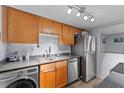 Compact kitchen featuring stainless steel appliances and light wood cabinets at 758 E Michigan St # 208, Orlando, FL 32806