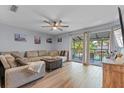 Bright living room with sliding glass doors to a screened patio and pool view at 758 E Michigan St # 208, Orlando, FL 32806