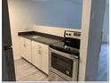 Bright kitchen with white cabinetry, stainless steel appliances, and modern countertops at 7604 Forest City Rd # 11, Orlando, FL 32810