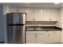 Bright kitchen with white cabinetry, stainless steel appliances, and modern countertops at 7604 Forest City Rd # 11, Orlando, FL 32810
