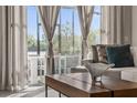 Bright living room featuring a modern coffee table, stylish sofa, and large sliding glass doors to outdoor living at 772 Driving Range Ct, Kissimmee, FL 34747