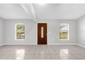Bright living room featuring neutral paint, tile floors, and natural light from dual windows at 778 Del Prado Dr, Kissimmee, FL 34758