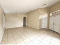 Spacious living room with tile flooring, neutral walls, and open access to other rooms at 928 Chanler Dr, Haines City, FL 33844